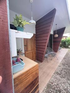 a living room with a wooden floor and a house at Apartamentos en el Centro de Puerto Viejo in Puerto Limón