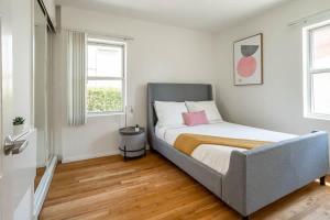 a bedroom with a bed with a pink pillow on it at HUGE Cozy 2bd 1ba Apt w Office & Back Yard in Los Angeles