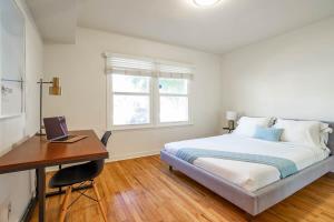 a bedroom with a bed and a desk with a computer at HUGE 2BR FAST WIFI Washer Dryer inside Unit 4 Guests in Los Angeles