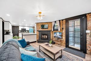 a living room with a couch and a fireplace at Charming & Updated Garden Level in Heart of Denver in Denver