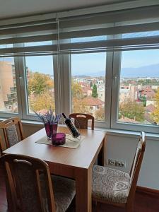 a dining room table with a view of a city at Apartman Jasmin in Vrnjačka Banja