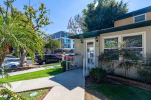 a house with a gate and a driveway at Spacious 2BR filled with Sunshine and fast WIFI in Los Angeles
