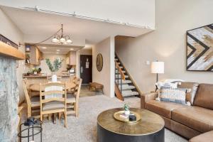 a living room with a couch and a table at NEW Ski-in Ski-Out at Peak 9 Walk to Super Chair Lift in Breckenridge