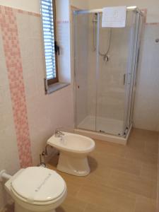 a bathroom with a toilet and a shower at Zeus casa vacanze in Paestum +21 photos