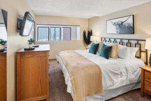 a bedroom with a large bed and a television at NEW Ski-in Ski-Out at Peak 9 Walk to Super Chair Lift in Breckenridge