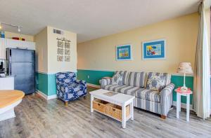 a living room with a couch and a table at 1003 Ocean Breeze home in Carolina Beach
