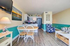 a kitchen and living room with a table and chairs at 1003 Ocean Breeze home in Carolina Beach