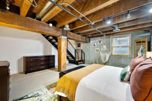 a bedroom with a large bed and a staircase at NEW Downtown Denver City Loft-Great Walkability in Denver