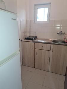 a small kitchen with a sink and a counter at STUDIOS MONA in Agios Georgios