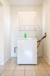 a small white refrigerator in a white room at Very Peaceful 2BR with Desks & Super Fast Wifi in Los Angeles