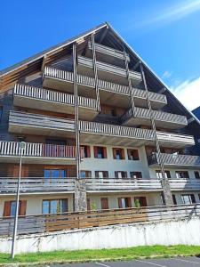 a large apartment building with balconies on the side of it at Le 340 C super besse 2 nuits minimum in Besse-et-Saint-Anastaise +10 photos