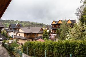 a group of houses in a town with trees at Poronin Mountain Apartments in Poronin