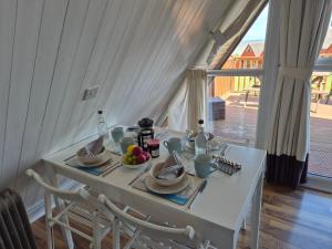 a white table with plates of food on top of it at WOW! Amazing SEA VIEWS at Coastal chalet in Kingsdown Park with pool No 40 in Kingsdown