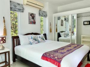 a bedroom with a bed with white sheets and pillows at Villa Nap Dau Crown Private Pool Villa Phuket in Ban Klang +109 photos