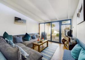 uma sala de estar com um sofá e uma televisão em 2 Bed cottage in a fantastic sea front setting em Appledore