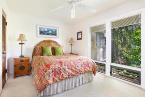 ein Schlafzimmer mit einem Bett und einem Fenster in der Unterkunft Manualoha 101 in Kipu + 6 Fotos