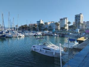 a boat docked in a marina with other boats at Baleares III Apartamento a 100 metros de la arena in Los Mártires