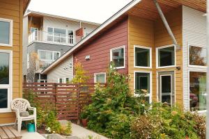 a house with a fence and a chair in a yard at NN - The Kit - Downtown 1-bed 1-bath in Whitehorse