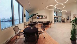 a restaurant with tables and chairs in a room with windows at Quality Inn & Suites in Gatineau