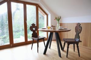 a table and chairs in a room with a window at Villa Rodica, Bled in Bled
