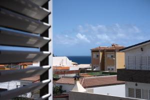 a view of the ocean from the roofs of buildings at Integral Coliving Surf Yoga House in El Médano