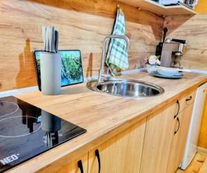 a kitchen counter with a sink in a tiny caravan at Къмпинг и Бунгала Брусен Хил - Camping and Bungalows Brusen Hill 