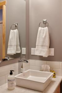 a bathroom with a sink and towels on a wall at NN - The Kluane - Whistlebend 3-bed 2-bath in Whitehorse