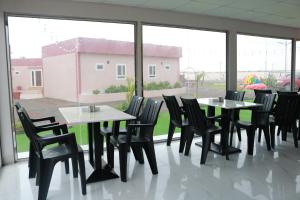 a room with tables and chairs and a large window at Lina Dreamland Resort in Billah