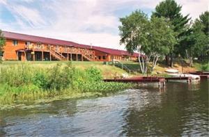 a building next to a body of water with a bridge at Eagle River Inn and Resort in Eagle River