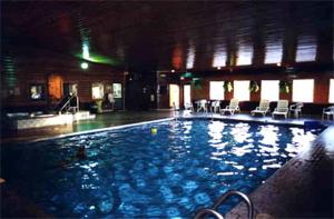 a large swimming pool with chairs in a building at Eagle River Inn and Resort in Eagle River