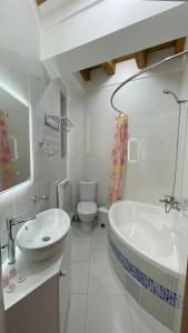 a bathroom with a sink and a tub and a toilet at Mahbubakhon Guest house in old city in Bukhara +54 photos