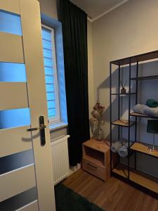 a room with a room with a window and a door at Nowy Apartament in Mińsk Mazowiecki