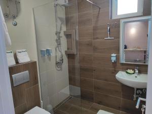 a bathroom with a shower and a sink at AIRPORT APARTMANI HAPPY HOUSE free parking & early check-in in Surčin +35 photos