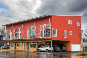 a red building with cars parked in front of it at NN - The Flame - Downtown 1-bed 2-bath in Whitehorse