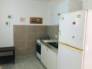 a kitchen with a white refrigerator and a stove at Con Garage - Casa Acogedora en el Centro de la Ciudad in Santiago del Estero