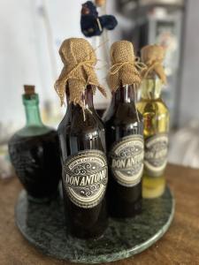 three bottles of wine sitting on a table at Casaca in Concepción de Ataco