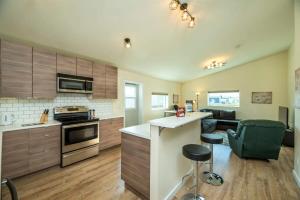 a kitchen with wooden cabinets and a counter top at NN - The Lavendar A - Whistlebend 2-bed 1-bath in Whitehorse