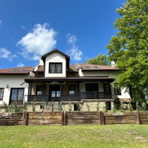 a house with a wooden fence in front of it at Геша Форест in Dryanovo