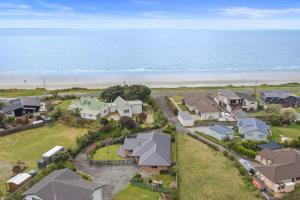 an aerial view of a house with the beach at Pohara Beach Life in Pohara