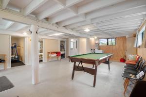 a living room with a pool table in it at Parapara Beach Escape in Parapara 