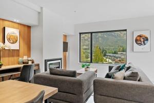 a living room with two couches and a table at The Terrace at La Residence du Parc in Queenstown