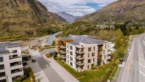 an aerial view of a building with mountains in the background at The Terrace at La Residence du Parc in Queenstown