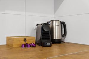 a coffee maker sitting on a counter with purple shoes at Casa Oasis IV: Modern, Nespresso & Thermennähe in Bad Füssing