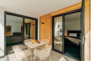 a room with a table and chairs and a bedroom at Vue Alpine - La Residence du Parc in Queenstown