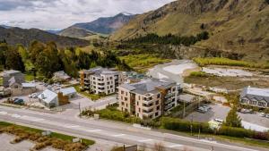 an aerial view of a building with mountains in the background at Vue Alpine - La Residence du Parc in Queenstown