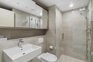 a bathroom with a sink and a toilet and a shower at Coronet Bliss - La Residence du Parc in Queenstown +10 photos