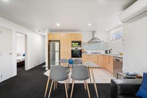a kitchen and living room with a table and chairs at Alpine Retreat in Wanaka