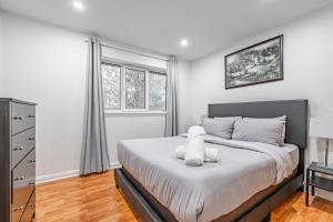 a bedroom with a bed and a window at Littlewood Properties in Toronto