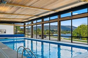 a swimming pool with a view of the mountains at Lake View Studio Apartment in Wanaka