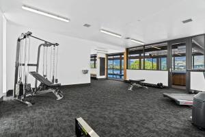 a gym with two treadmills and two treadms and a treadmill at Lake View Studio Apartment in Wanaka